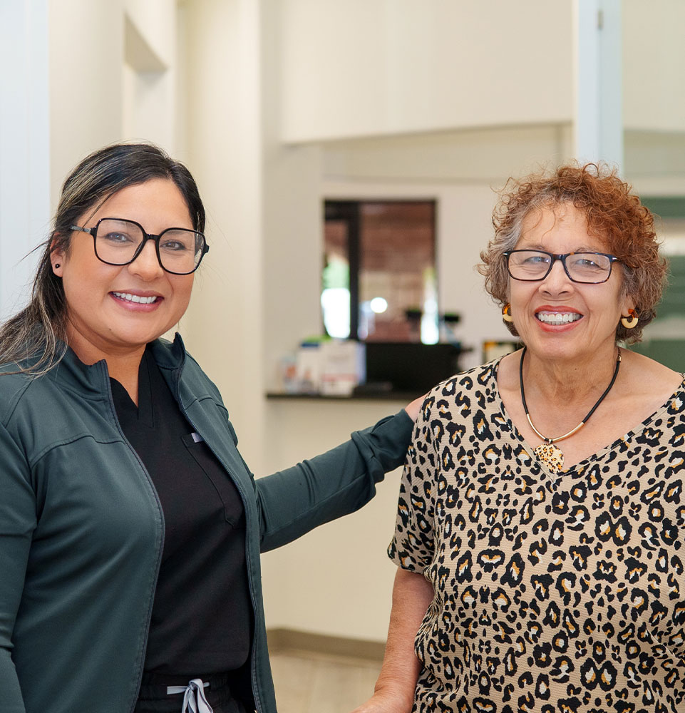 staff member and patient smiling